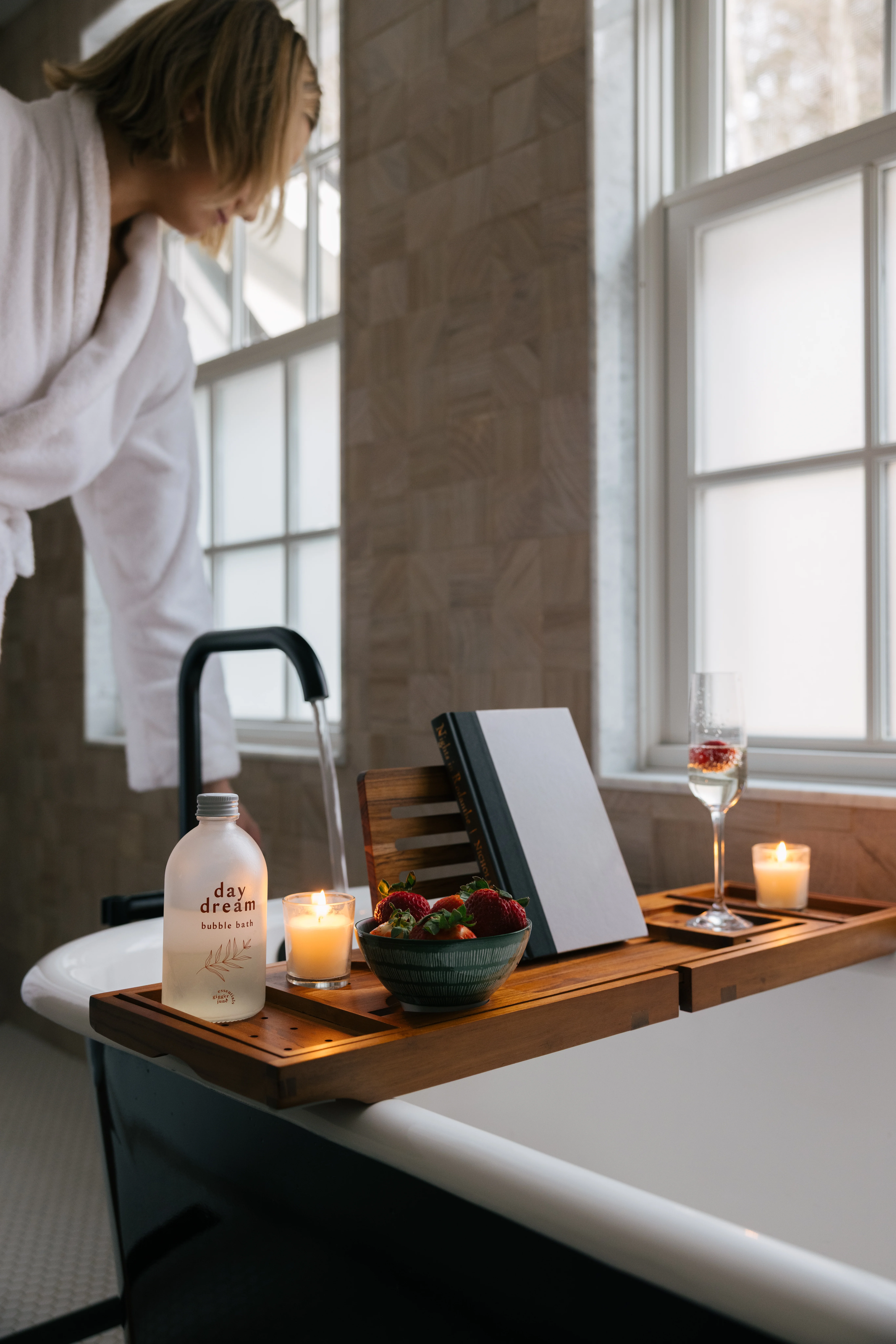 Master bath lifestyle shot with candles, bath salts, and a relaxing soaking tub scene